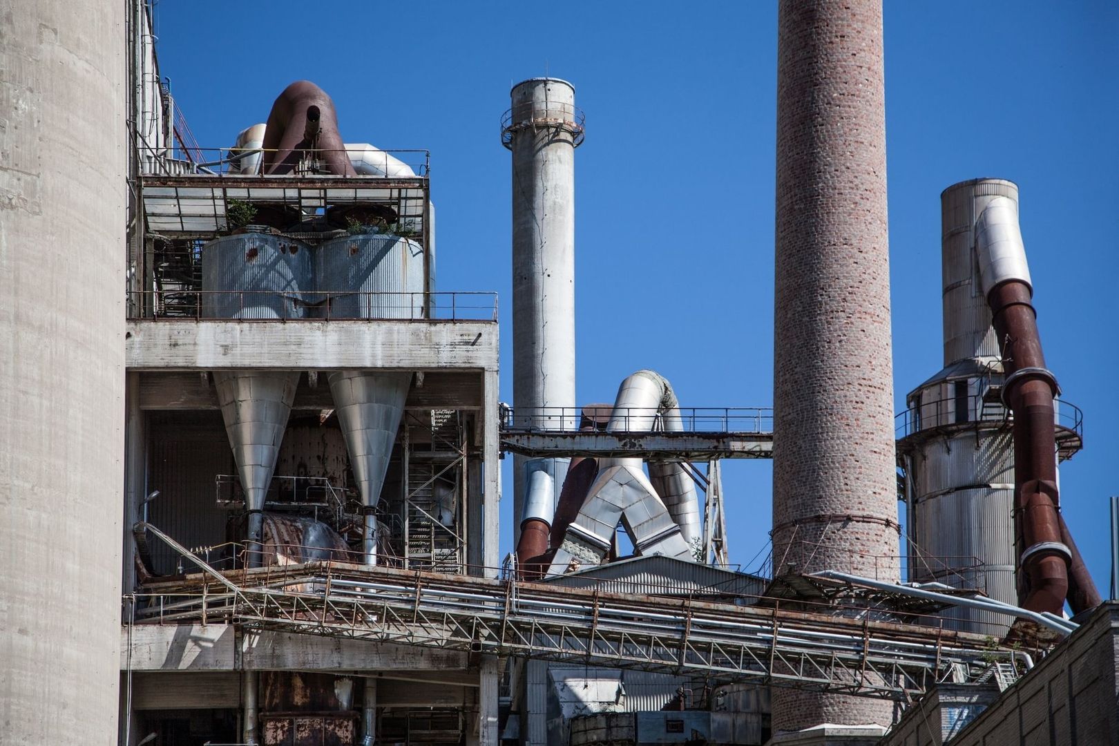Industrielle Prozessanlage mit Rohren, Behältern und hohen Schornsteinen